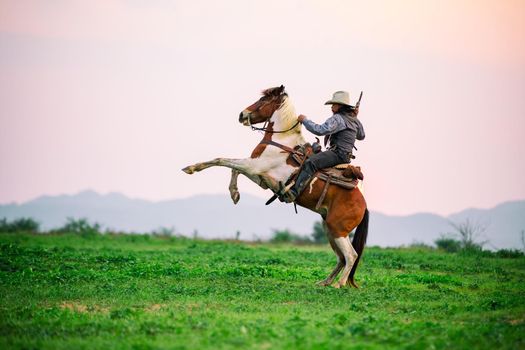 cowboy and horse at first light,mountain, river and lifestyle with natural light background	