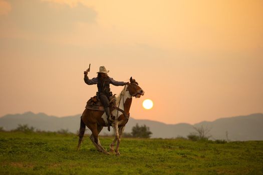 cowboy and horse at first light,mountain, river and lifestyle with natural light background	