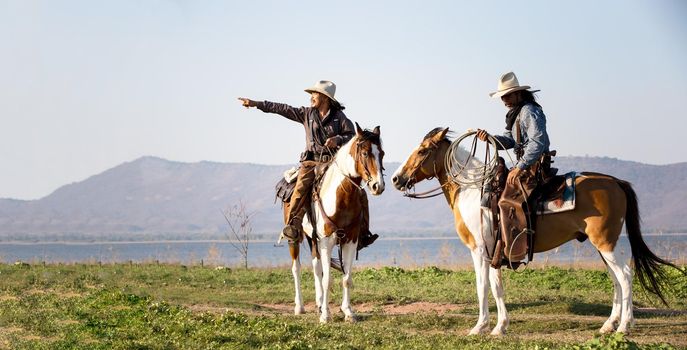 cowboy and horse at first light,mountain, river and lifestyle with natural light background	