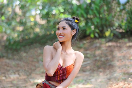 Portrait of Beautiful rural Thai woman wear Thai dress with elephant in Surin Province, Thailand