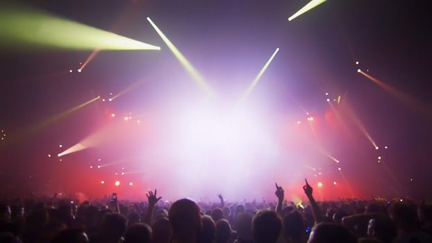 Concert Music festival and Celebrate. Party People Rock Concert. Crowd Happy and Joyful and Applauding or Clapping. Celebration party festival happiness. Blurry night club. Concert Show with DJ Music festival EDM on Stage