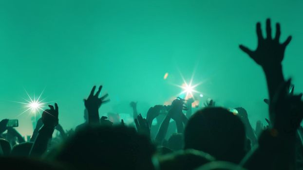 Concert Music festival and Celebrate. Party People Rock Concert. Crowd Happy and Joyful and Applauding or Clapping. Celebration party festival happiness. Blurry night club. Concert Show with DJ Music festival EDM on Stage