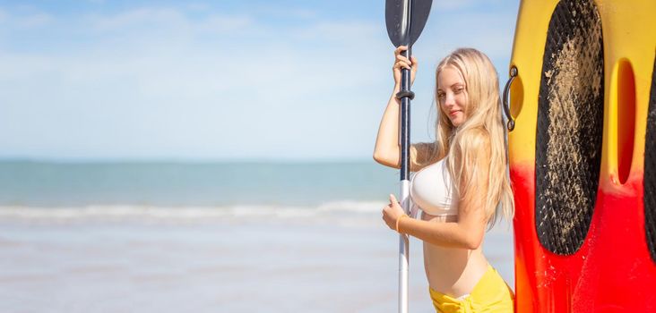 Woman on stand up paddle board. Having fun during warm summer beach vacation holiday, active woman