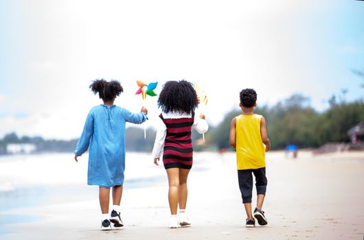 Kids playing running on sand at the beach