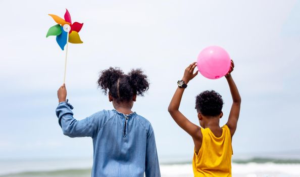 Kids playing running on sand at the beach