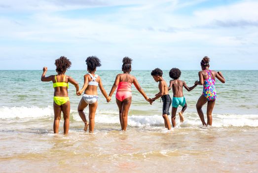 Kids playing running on sand at the beach