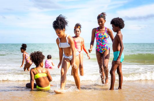 Kids playing running on sand at the beach