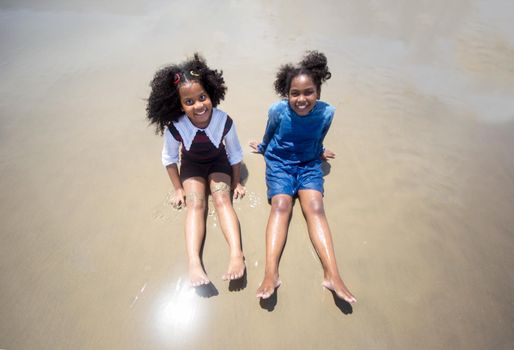 Kids playing running on sand at the beach