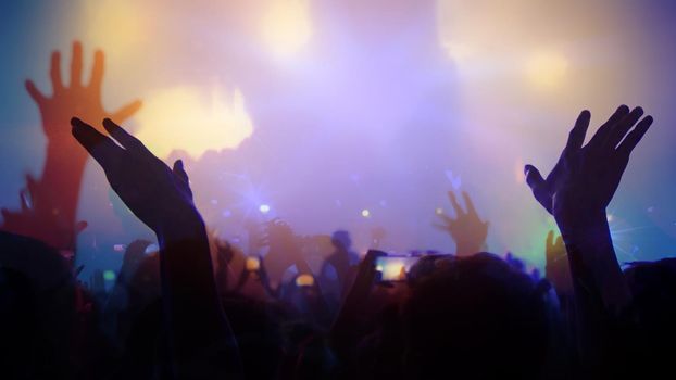 Concert Music festival and Celebrate. Party People Rock Concert. Crowd Happy and Joyful and Applauding or Clapping. Celebration party festival happiness. Blurry night club. Concert Show with DJ Music festival EDM on Stage