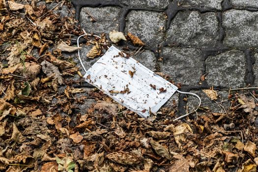 Surgical white masks on the ground. Corona virus pollution. Leherheide, Bremerhaven.