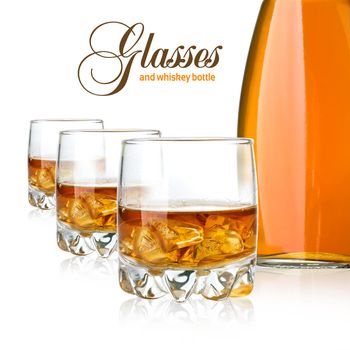 Whisky bottle glasses and ice on white background