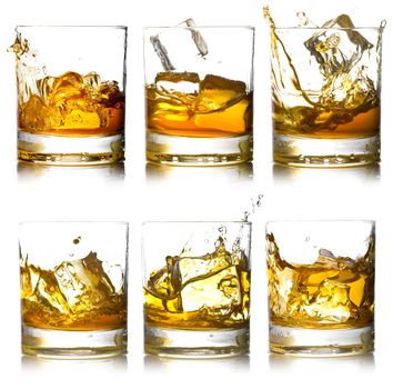 Glass of scotch whiskey and ice on a white background