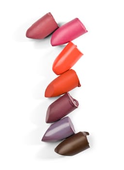 close up of a lipstick stack on white background