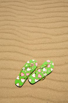 flip flops on beach sand