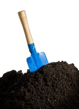 Close-up of organic soil and spade isolated on white background