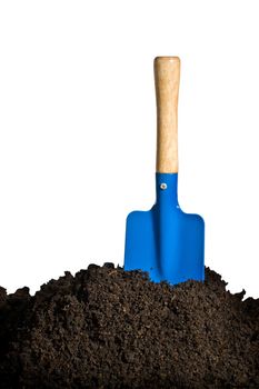 Close-up of organic soil and spade isolated on white background