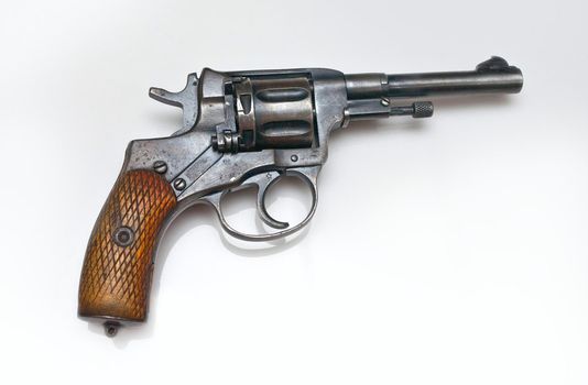 Old revolver on white background