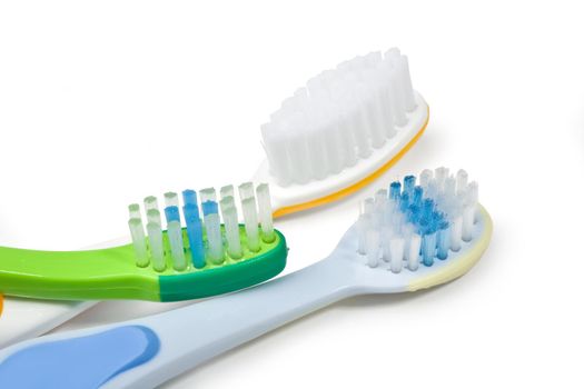 Colorful toothbrushes on white background with copy space.