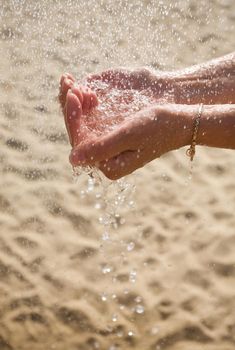 drops of water falling into the hands