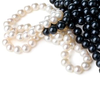 White and black pearls isolated on a white table
