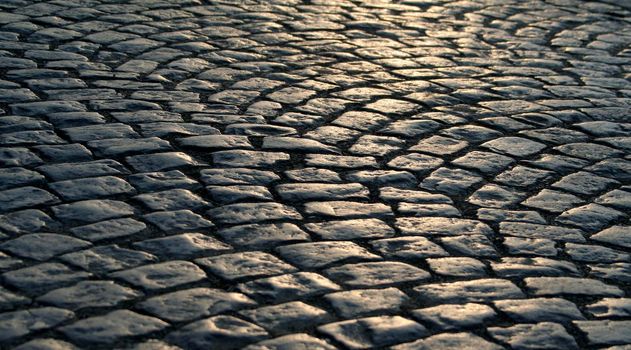 Close-up of the old pavement stones in dark colors