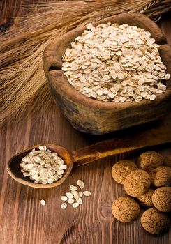 oatmeal and cookies on a wooden background