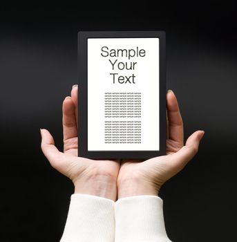 Female hands with electronic book on the dark background