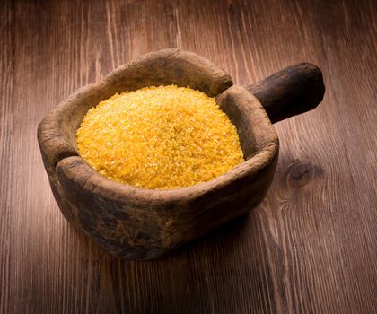 corn grits on wooden background