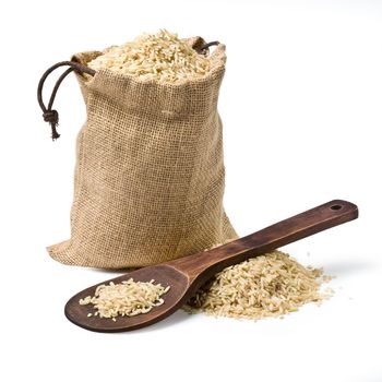 bag of rice and a wooden spoon on a white background. keeping paths