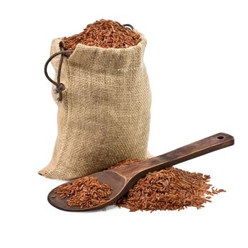 bag of  brown rice and a wooden spoon on a white background. keeping paths