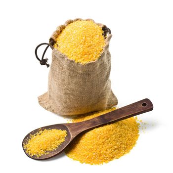 bag of ground corn and a wooden spoon on a white background. keeping paths