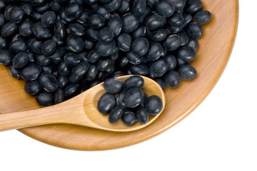 wooden plate with black soy beans on white background with clipping paths