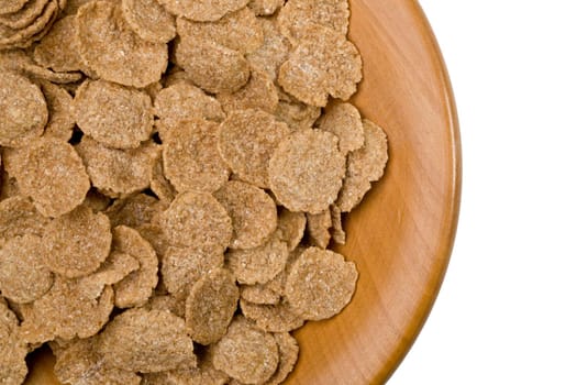 rye flakes on a wooden plate close up