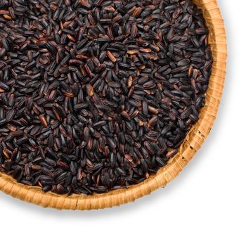 straw plate with black rice on a white background