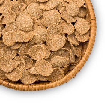 close-up of wheat flakes in a bowl of straw isolated on white background