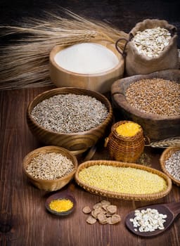 crops in various dishes on the background of the old wooden