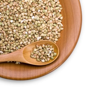 green buckwheat close up in a wooden bowl