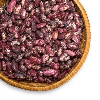 Wicker plate with grains beans close-up on white background