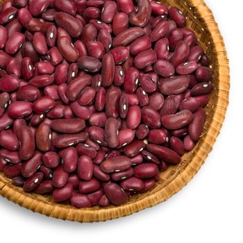 Wicker plate with grains beans close-up on white background