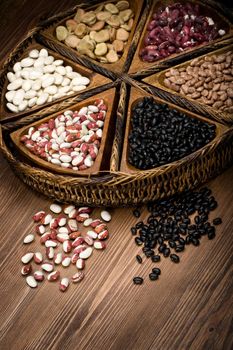 mix of beans and peas on a wooden plate