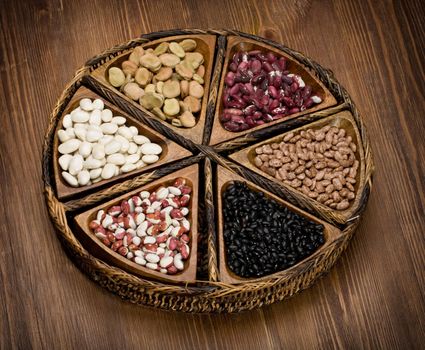 mix of beans and peas on a wooden plate