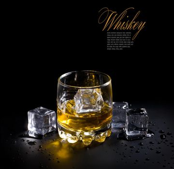 glass of whiskey and ice  over a black background