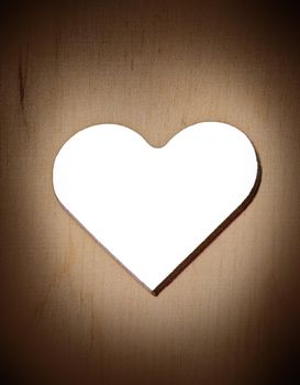 silhouette of heart carved on a wooden surface