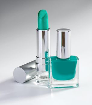nail polish and lipstick emerald color on a light background