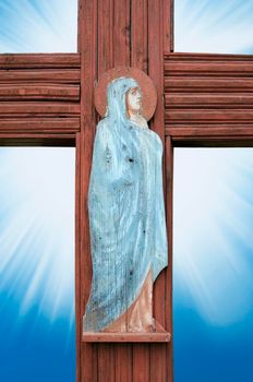 Virgin Mary prays for the old wooden cross