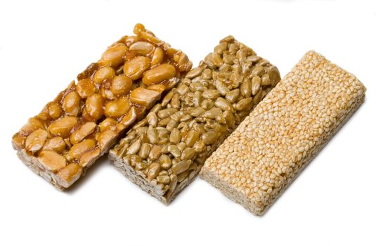 sunflower seeds, sesame ,peanuts in sugar syrup isolated on a white background