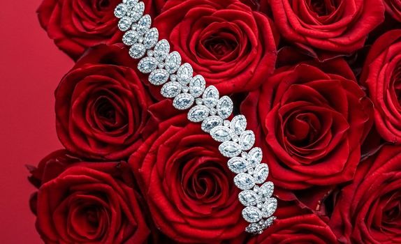 Gemstone jewellery, wedding fashion and luxe shopping concept - Luxury diamond bracelet and bouquet of red roses, jewelry love gift on Valentines Day and romantic holidays present