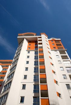 Modern white building with balcony on a blue sky