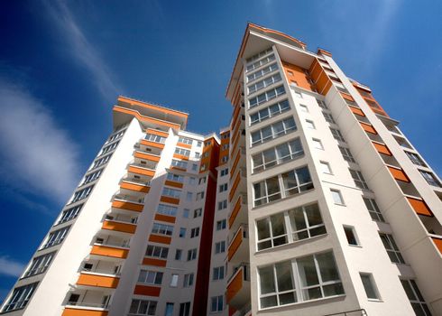 Modern apartment building against blue sky background