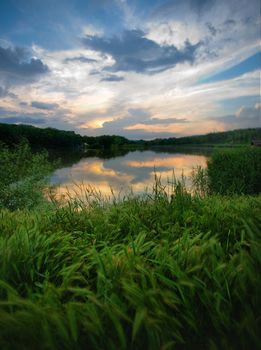 sunset on the old lake in the woods